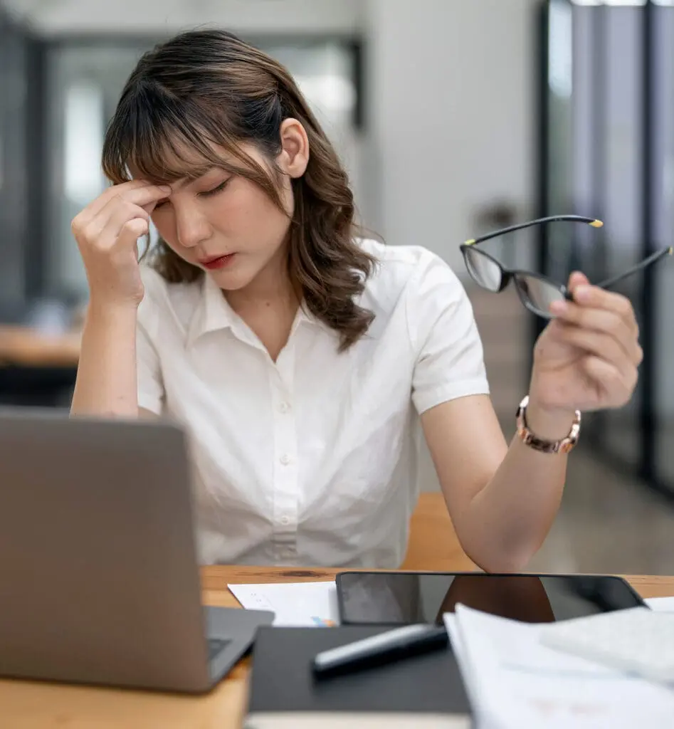 Tired asian business woman with headache at office, f