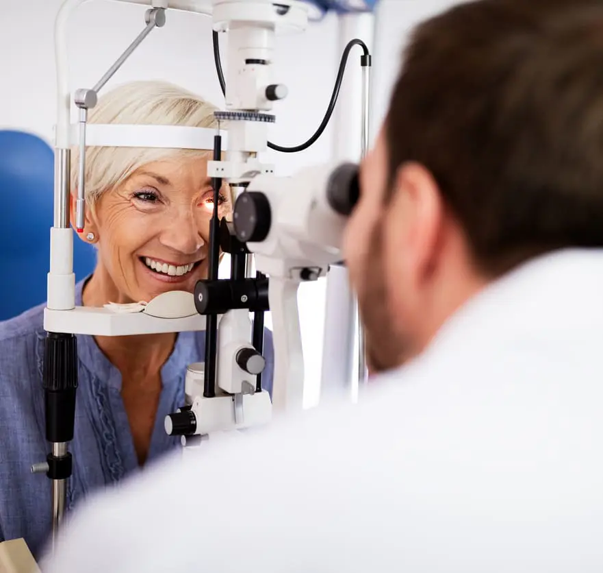 Optometrist examining senior woman
