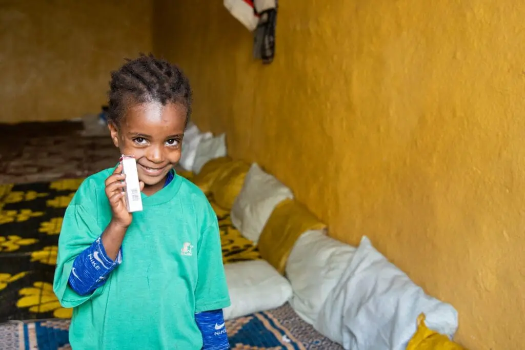 Sitra, 6, poses holding tetracycline eye ointment at her home in Gurage Zone, Wolkitae town.