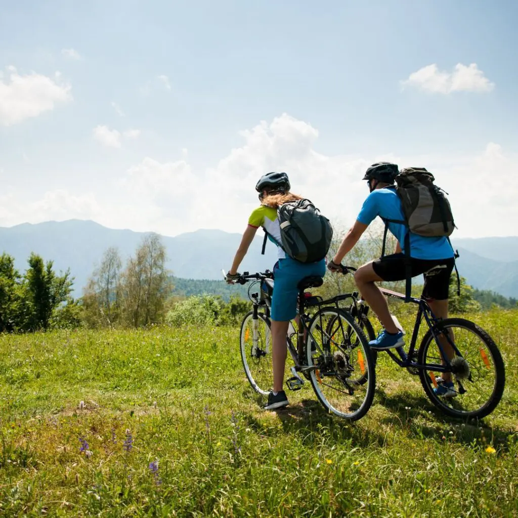 Centre for Sight stock image for vision correction dos and don't after lasik two cyclists in field looking over view long bike ride