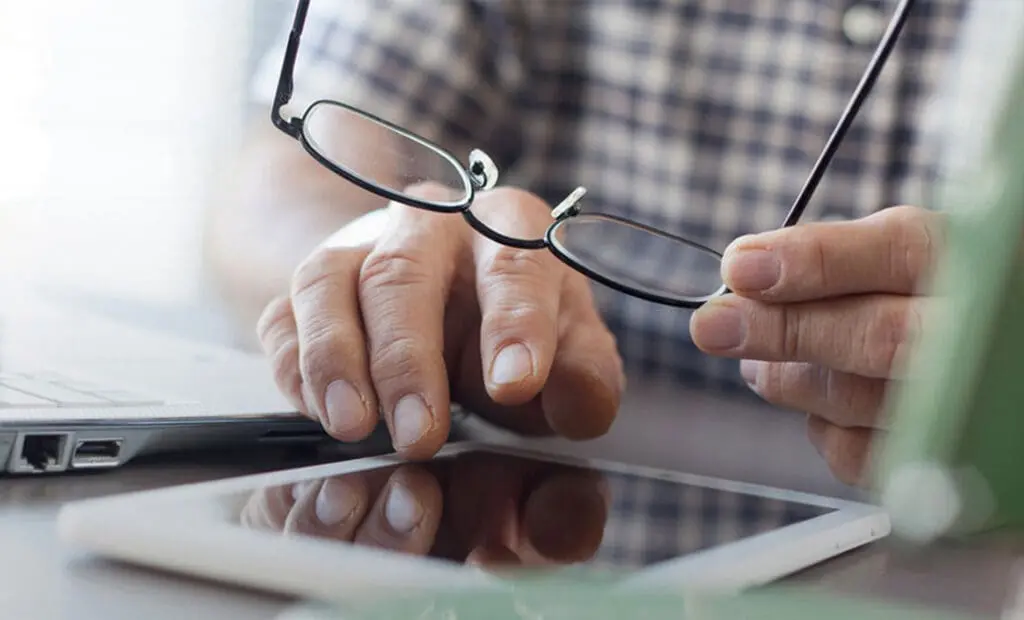Man struggles to see iPad without glasses due to poor eyesight