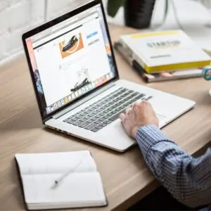 Centre for Sight Man using computer to work notepad and pen stock image for blog post Computer Vision Syndrome and Eye Strain