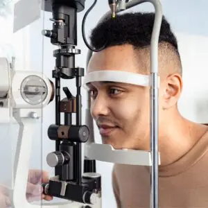 Centre for Sight Man having eyes tested at ophthalmology clinic dark hair chin on chin rest stock image for 10 tips for laser eye surgery patients