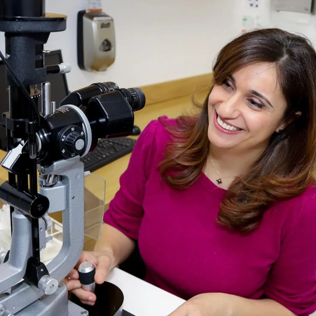 Centre for Sight eye surgeon Shahrnaz Izadi looking at eye tests and examining patient in consultant room