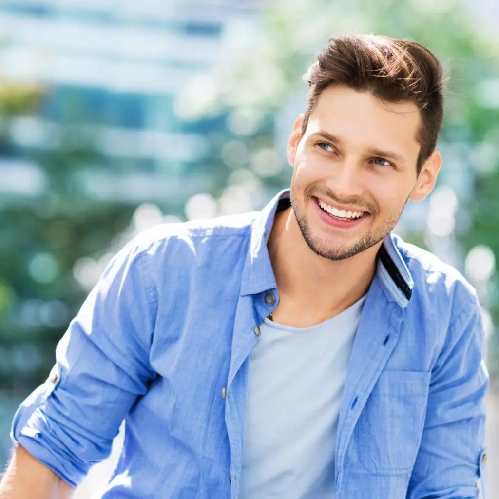 Centre for Sight Young Man in Light Blue Shirt outside smiling stock image