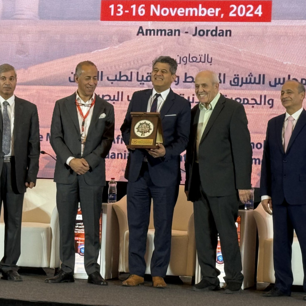 Men on stage accepting award at the 15th International Congress of the Jordanian Ophthalmological Society