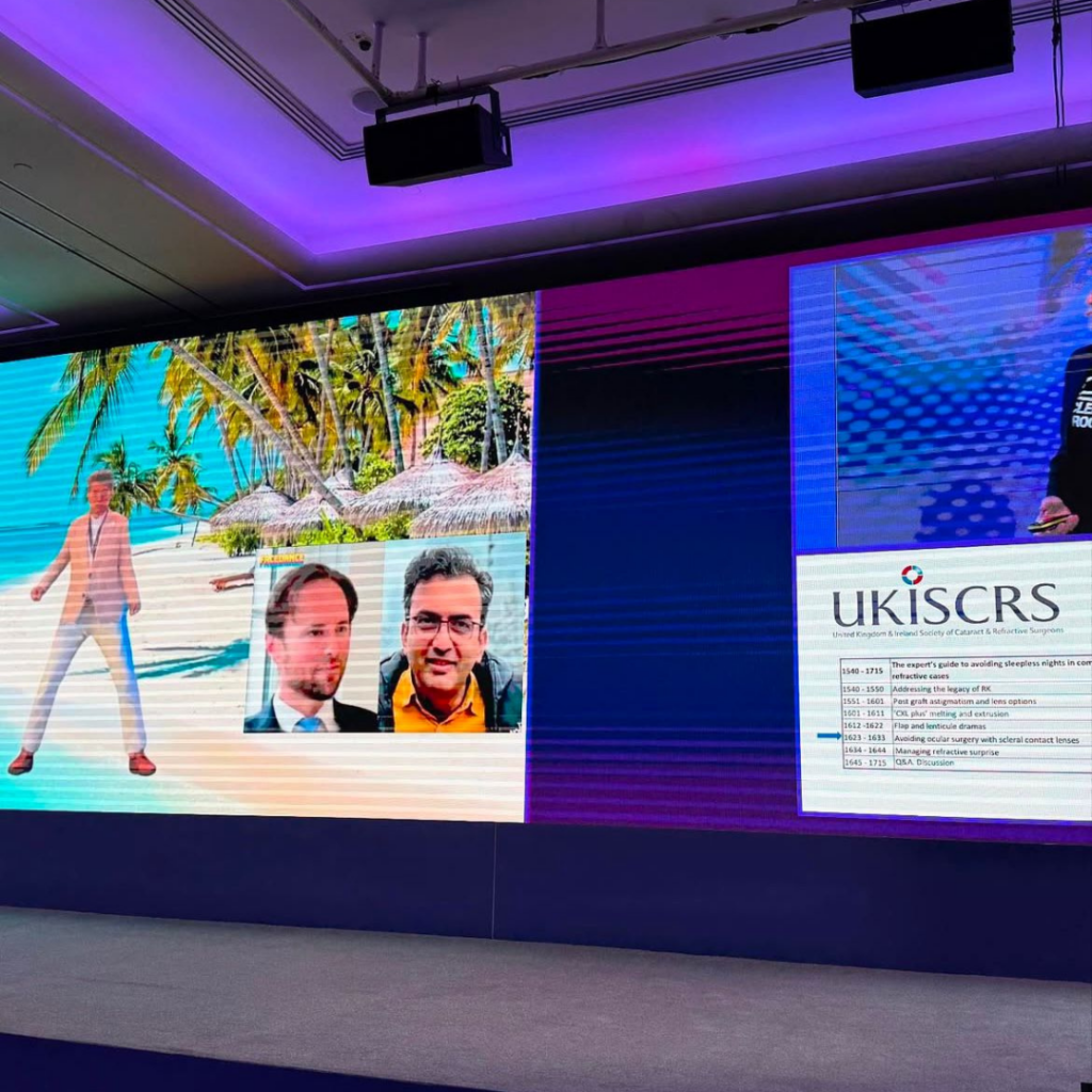 Screen on stage prenting people and the celebration of 75 years of the Intraocular Lens Implant