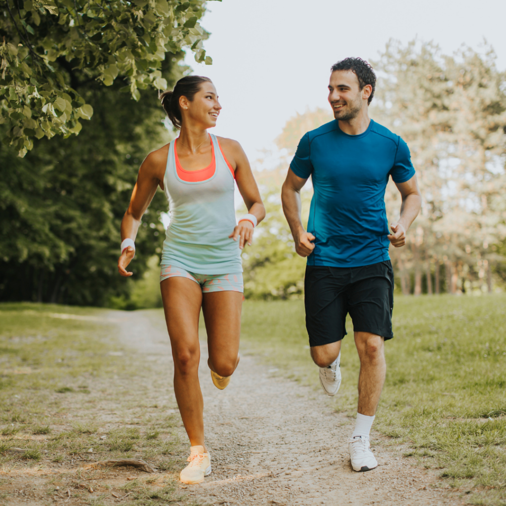 Young couple running in the park on a summers day