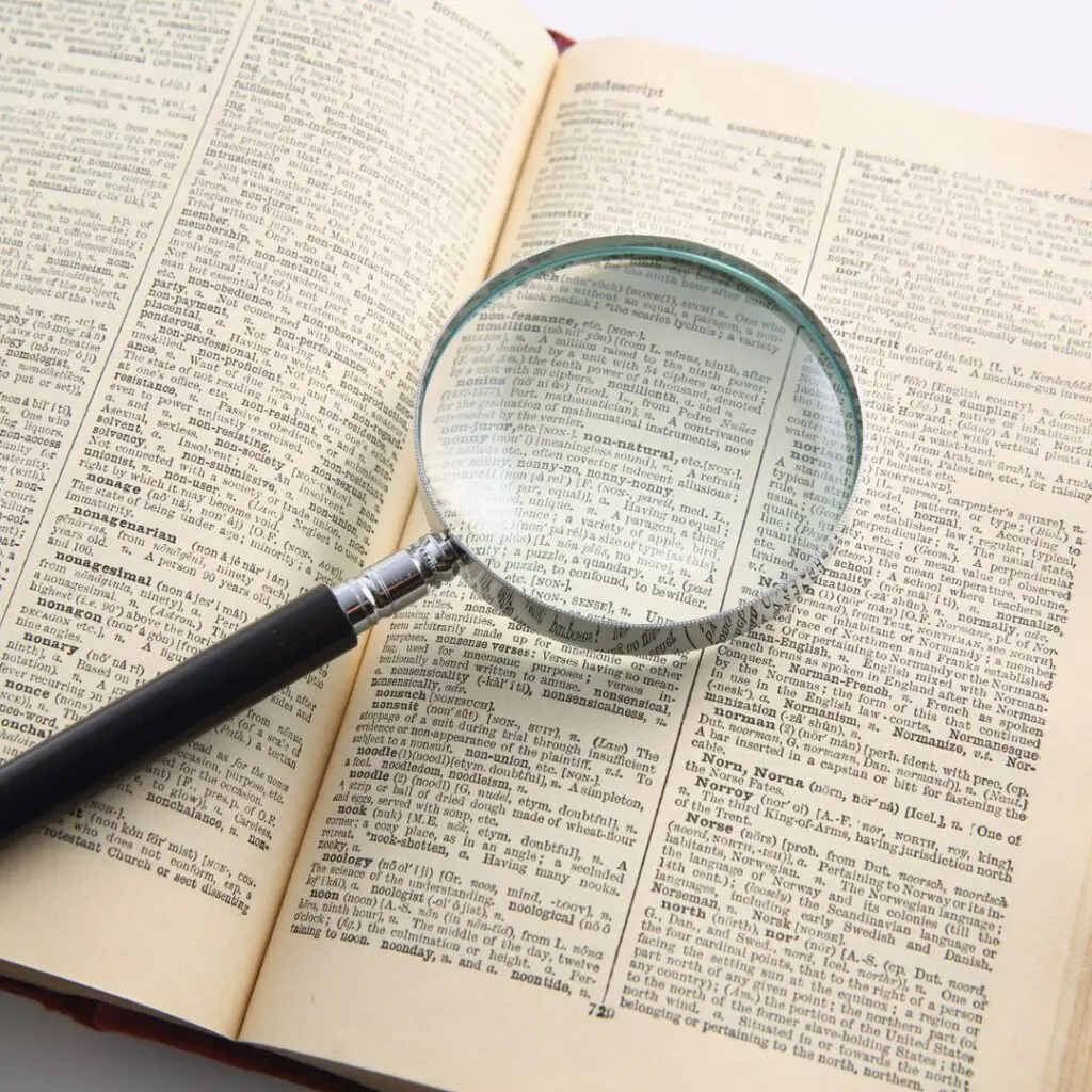 Centre for Sight magnifying glass on top of pages of a book to demonstrate presbyopia stock image for blog post who is NOT suitable for laser eye surgery by Sheraz Daya