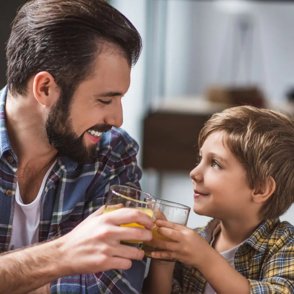 Centre for Sight Implantable Contact Lens Treatment Page father and son cheers glasses smiling young boy with juice