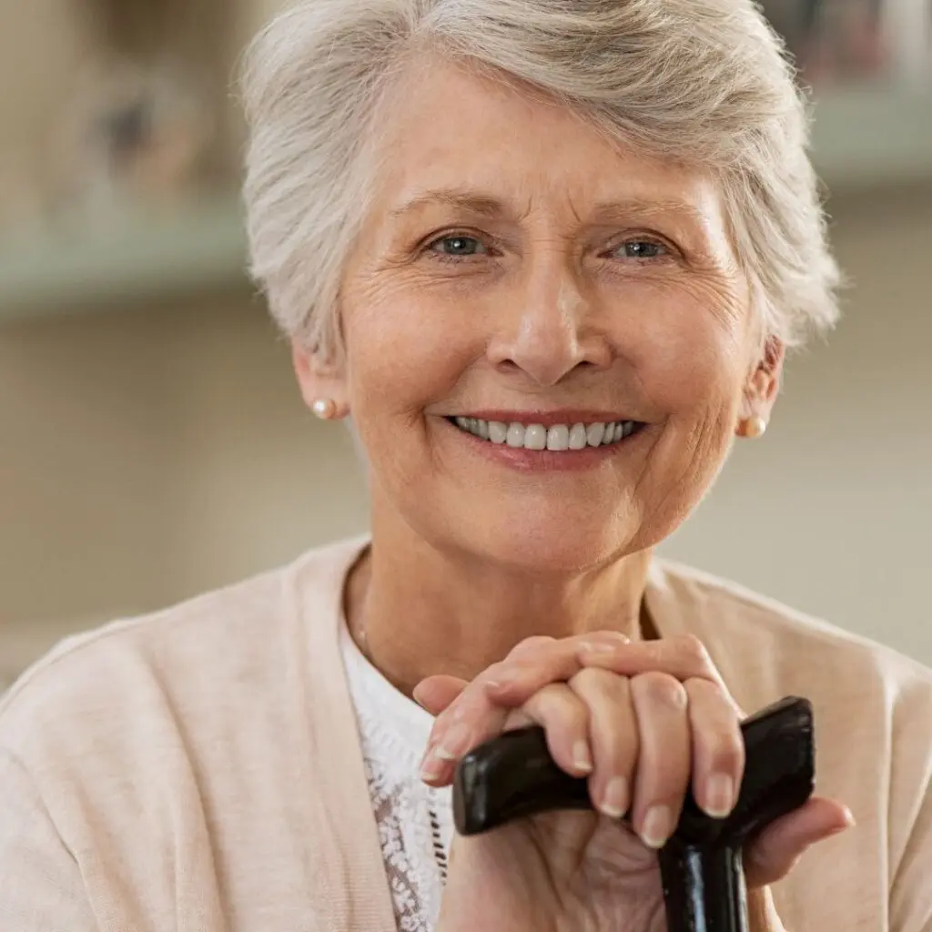 Centre for Sight risk of falls with cataracts elderly lady with walking stick smiling at camera grey hair stock image