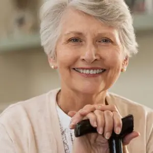 Centre for Sight risk of falls with cataracts elderly lady with walking stick smiling at camera grey hair stock image