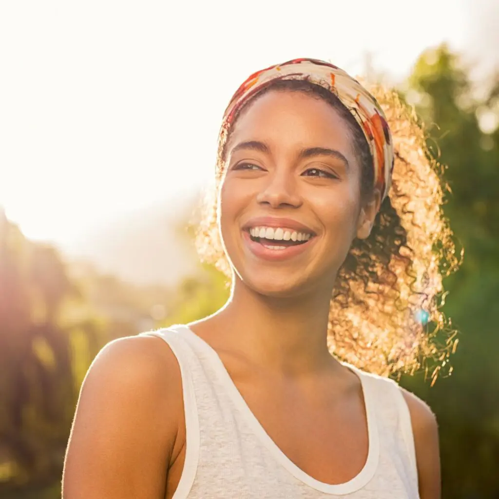 Centre for Sight dark hair female smiling outside after laser eye surgery stock image