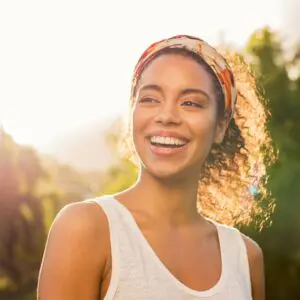 Centre for Sight dark hair female smiling outside after laser eye surgery stock image