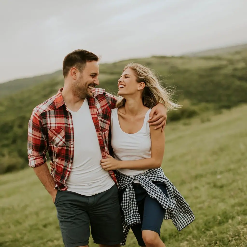 Centre for Sight young couple walking in field after laser eye surgery sussex