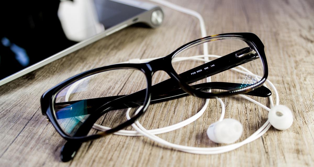 Glasses and headphones on desk