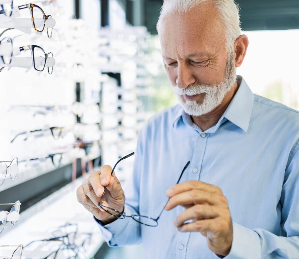 Senior man trying on eyeglasses