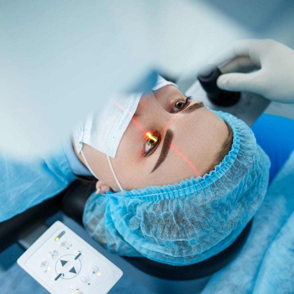 Centre for Sight stock image for laser eye surgery young lady undergoing surgery wearing mask and hairnet on operating bed