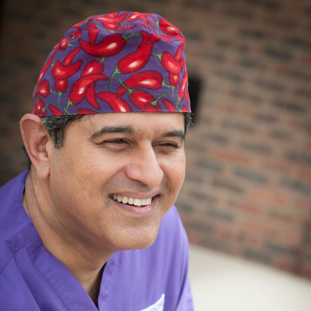 Centre for Sight Sheraz Daya Medical Director in scrubs sat in reception for professional photography
