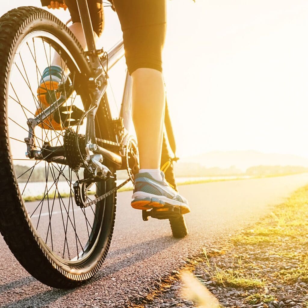 Centre for Sight stock image of cyclist on road dirtbike female trainers cycling shorts