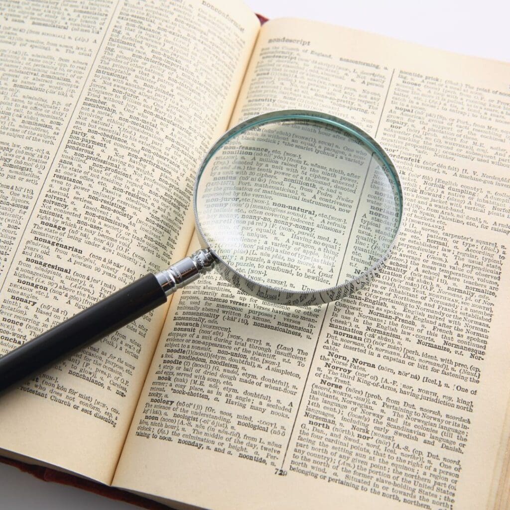 Centre for Sight magnifying glass on top of pages of a book to demonstrate presbyopia stock image for blog post who is NOT suitable for laser eye surgery by Sheraz Daya