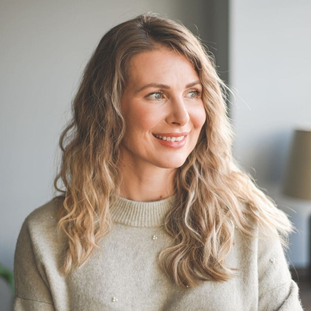 Centre for Sight middle aged blonde wavy haired lady in living room looking out window what are the benefits of laser eye surgery blog post long lasting results