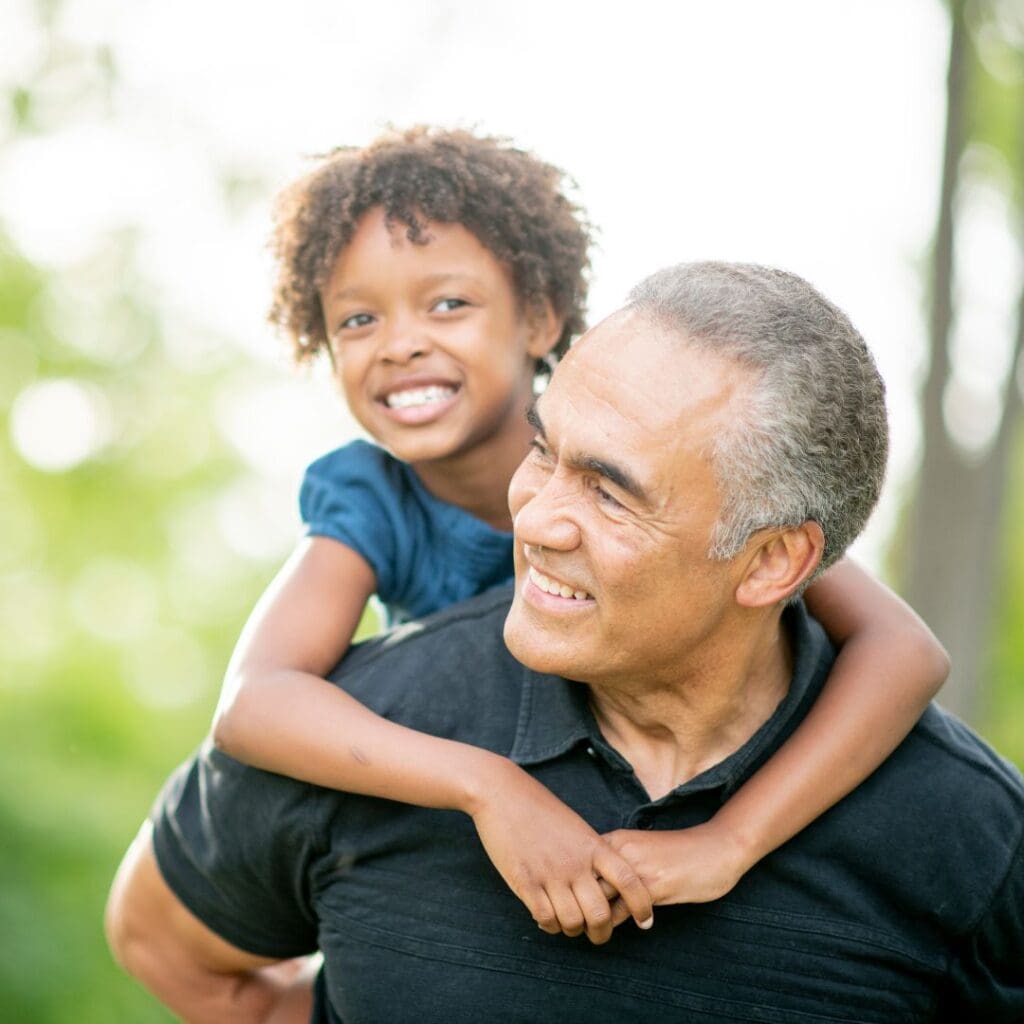 Centre for Sight laser cataract surgery landing page grandfather and child on back smiling grandad freedom from glasses and contact lenses stock image