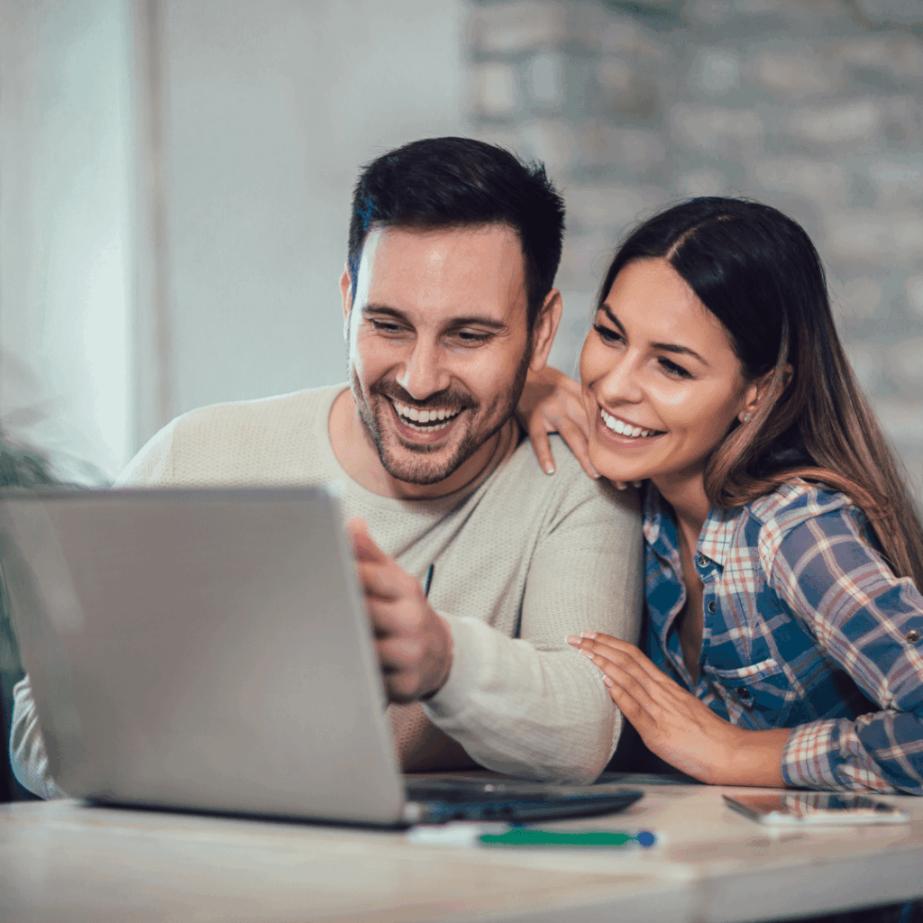 Why does pricing for laser eye surgery vary so much? 9 Young couple looking at laptop smiling doing research